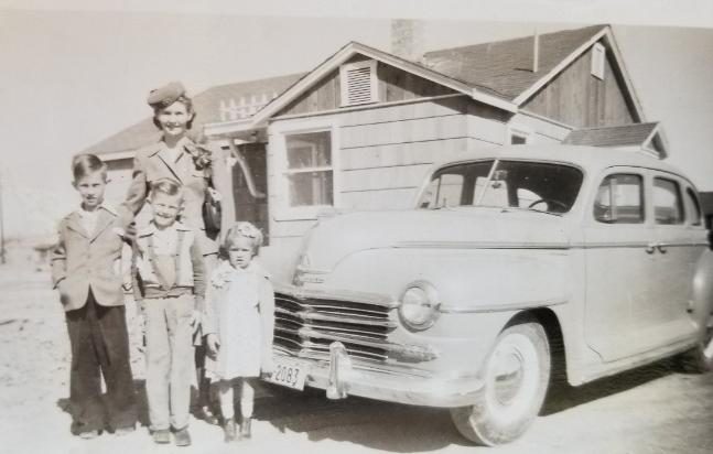 The Wilcox family with their car in front of the house, 1949