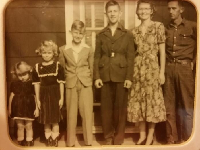 The family lined up in front of the house