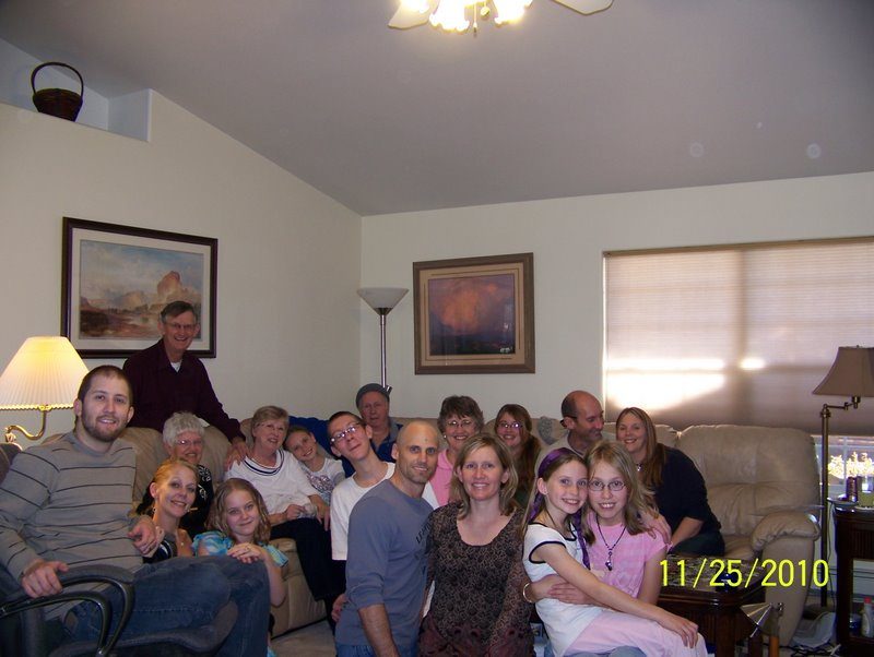 About twenty family members on and around the sofas of a living room, camera date stamp 11/25/2010