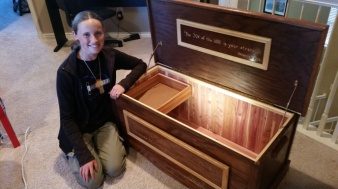 The finished dark-stained hope chest, lid raised, cedar interior visible