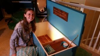 The finished teal-painted hope chest, lid raised