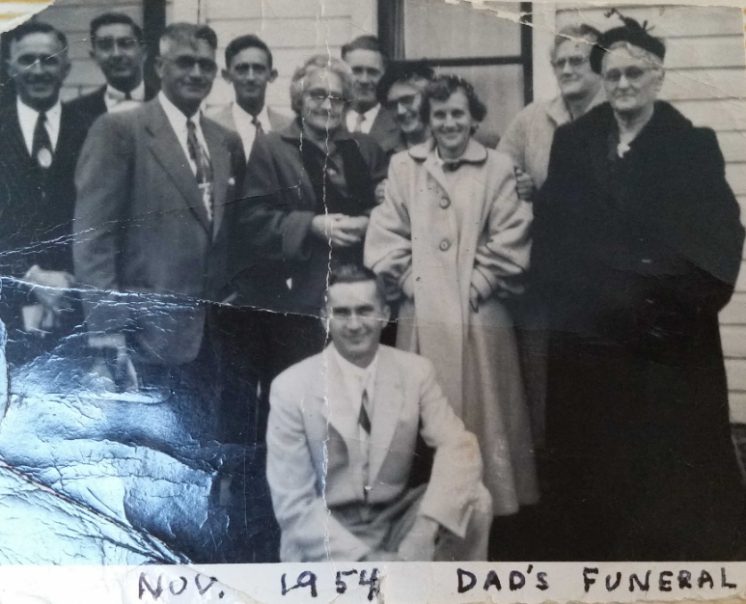 Family gathered outside a house, labelled Nov. 1954 Dad's Funeral